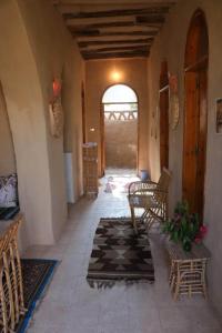 a hallway of a house with chairs and a table at Desert Rose Guesthouse in Luxor +41 photos