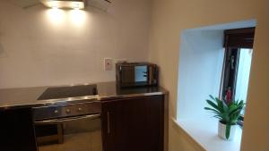 a kitchen with a microwave and a stove top oven at 10 The Kiln in Westport +6 photos