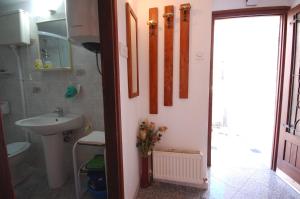 a bathroom with a sink and a toilet and a mirror at Apartment Cuomo by El-Pi Tours in Malinska