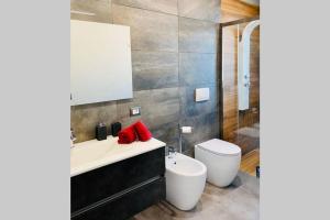a bathroom with a white sink and a toilet at Appartamento Moderno Soverato in Soverato Marina