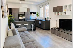sala de estar con sofá y cocina en Appartamento Moderno I Luxury Design, en Soverato Marina
