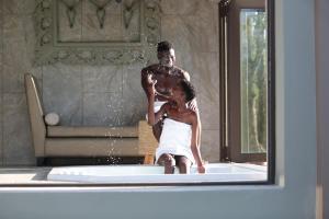 a man and a woman sitting in a bath tub at Palala Boutique Game Lodge and Spa in Tom Burke
