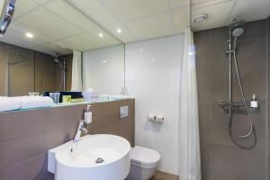 a bathroom with a sink and a shower and a toilet at Postillion Utrecht Bunnik in Bunnik
