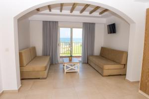 a living room with two couches and a view of the ocean at Mastichari Bay Hotel in Mastihari