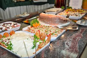 a buffet of different types of food on a table at Mastichari Bay Hotel in Mastihari
