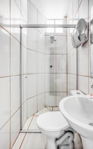 a white bathroom with a toilet and a sink at Hotel GMatos Belo Horizonte - Próximo a Rodoviária e Mercados Turísticos in Belo Horizonte