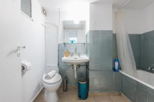 a bathroom with a toilet and a sink at Space Paradise Apartments in Athens