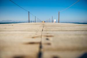 a row of poles on a pier at Mastichari Bay Hotel in Mastihari