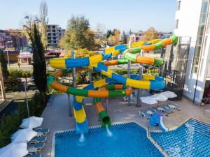 a water slide in a resort with a pool at Best Western PLUS Premium Inn in Sunny Beach