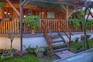 a house with a wooden staircase in front of it at Holiday Homes 4N in Gornje Jesenje
