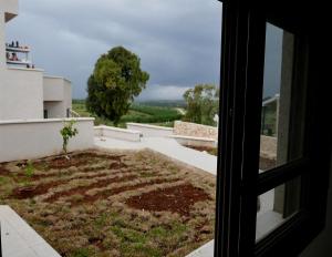 a window view of a garden from a house at נוריות בגלבוע 1 in Nurit