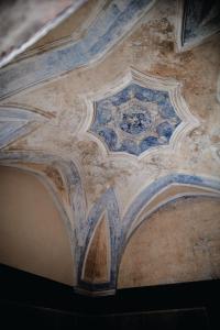 a ceiling of a building with a painting on it at Paragon 700 Boutique Hotel & SPA in Ostuni