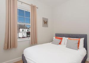 a bedroom with a white bed and a window at The BREWery Apartment in Sileby