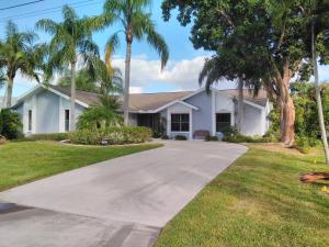 a house with palm trees in front of a driveway at Villa Angel's Haven in Cape Coral