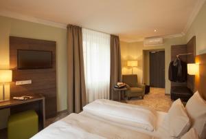 Postel nebo postele na pokoji v ubytování Hotel Jakob Regensburg DownTown, Best Western Signature Collection