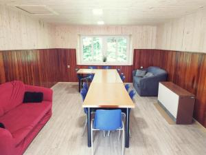 a room with a table and chairs and a couch at Chata u Brodu in Deštné v Orlických horách