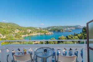 a balcony with a view of a lake at Odysseus Hotel in Paleokastritsa