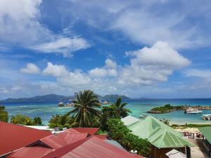 a view of a beach with boats in the water at Bord Mer City Apartments in La Digue