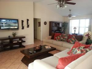 a living room with two couches and a tv at Villa Angel's Haven in Cape Coral