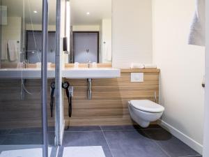 a bathroom with a sink and a toilet at Campanile PRIME - Marseille Aubagne in Aubagne