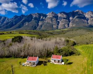 an aerial view of a farm with mountains in the background at Fraaigelegen Farm - Home of ADHARA EVOO in Tulbagh