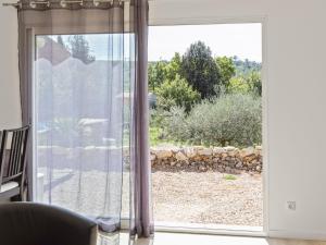 a sliding glass door with a view of a yard at Modern holiday home with private pool in Brignoles