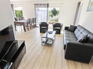 a living room with a couch and a table at Modern holiday home with private pool in Brignoles