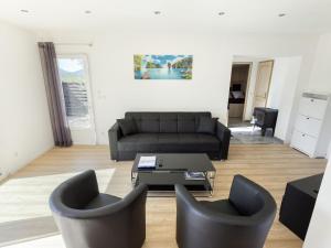 a living room with a couch and two chairs at Modern holiday home with private pool in Brignoles