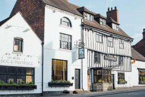 a white building on the corner of a street at Dog & Partridge by Chef & Brewer Collection in Tutbury