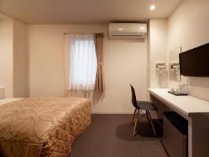 Postel nebo postele na pokoji v ubytování Hotel New Tohoku