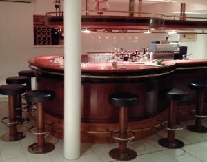 a large wooden bar with stools around it at Pension Edelweiss in Gargellen