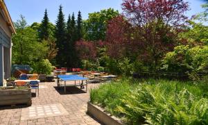 a patio with a ping pong table in a garden at Hostel 77 Bern in Bern