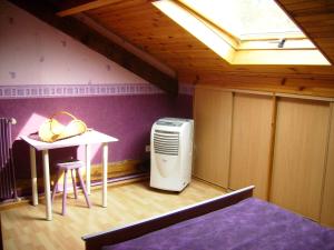 a room with a room with a table and a heater at Chambres d'Hôtes Le Perdigon in Estang +16 photos