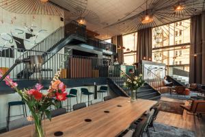 a dining room with a wooden table and a staircase at the niu Fender in Amsterdam
