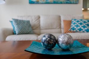 two balls sitting on a table in a living room at Casa al Compas De ROSARIO by Cadiz4Rentals in Cádiz