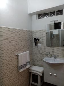 a bathroom with a sink and a toilet at Casa Vico Lepre in Noto