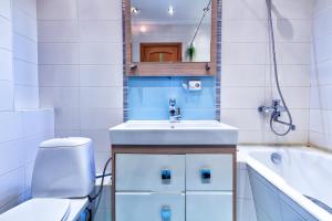a bathroom with a sink and a toilet and a tub at 20 Traveler's Choice in the City Center in Almaty