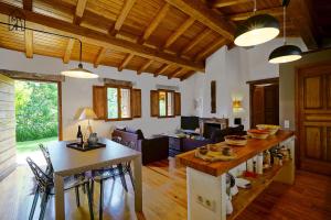 a kitchen and living room with a table and chairs at Les gites de Tasso in Tasso