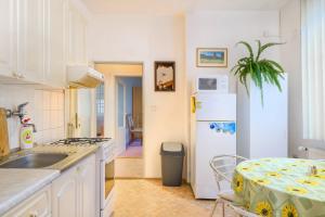 a kitchen with a table and a white refrigerator at Apartmán Hromovka Špindlerův Mlýn in Špindlerův Mlýn