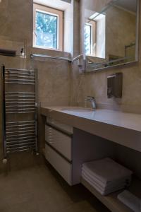 a bathroom with a sink and a mirror at VILA JEZERO in Kopaonik