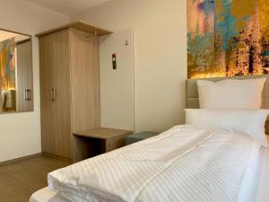 Ein Bett oder Betten in einem Zimmer der Unterkunft Thermalhotel Kemper