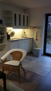 a kitchen with a chair and a table and a sink at Kelten-Ferienwohnung in Glauburg