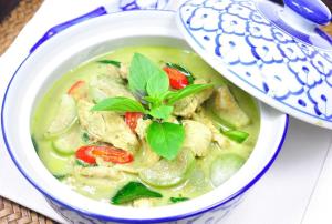 a bowl of chicken noodle soup in a blue and white bowl at Phusam Big Resort in Ko Mook