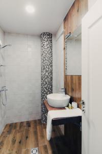 a bathroom with a sink and a shower at Hotel Magura in Haskovo
