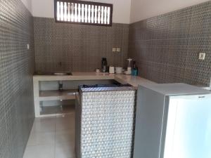 a bathroom with a sink and a counter in a room at Double One Villas Amed II in Amed