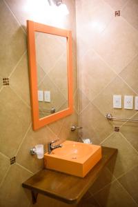 a bathroom with a sink and a mirror at AVEMAR Apart Hotel in Posadas