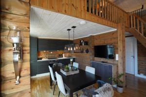 a kitchen and dining room with a black table and chairs at Lake View Apartment 2 bedrooms and loft in Stranda