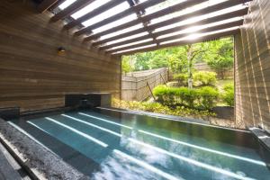 a swimming pool in the middle of a house at Hakuba Tokyu Hotel in Hakuba