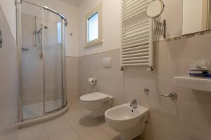 a bathroom with a toilet and a shower and a sink at Gimmi Hotel in Rimini +75 photos