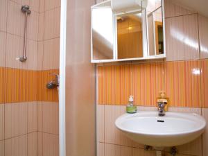 a bathroom with a sink and a mirror at Guest House Pri Treh Lipah in Ptuj